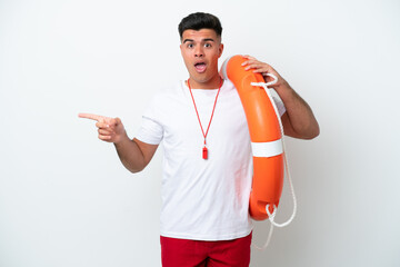 Young handsome man isolated on white background with lifeguard equipment and surprised while...