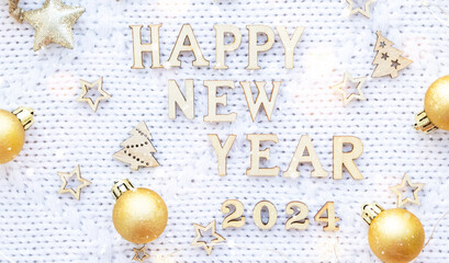 Happy New Year wooden letters and the numbers 2024 on cozy festive white knitted background with sequins, stars, lights of garlands. Greetings, postcard. Calendar, cover