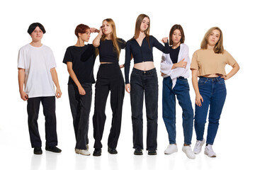 Group portrait of young attractive girls wearing in trendy casual outfit posing against white studio background. Concept of beauty, youth, emotions, fashion, style, modelling. Copy space for ad.
