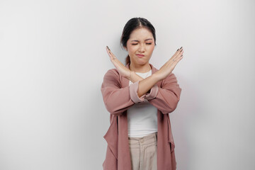 Beautiful Asian woman employee wearing cardigan with hand gesture pose rejection or prohibition with copy space