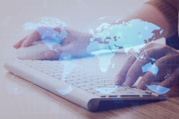 Young businessman using laptop with user icons