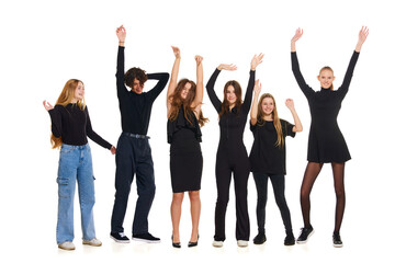 Fototapeta na wymiar Group portrait of happy, cheerful people, teenagers wearing smart casual outfits posing raising hands up on white studio background. Concept of beauty, youth, emotions, fashion, style, modelling.