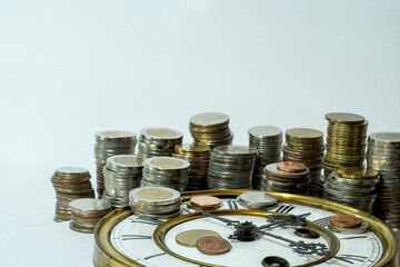 stack of coins on vintage clock