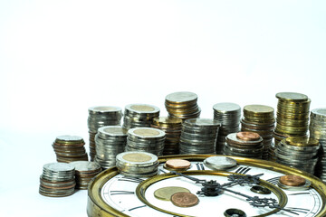 stack of coins on vintage clock