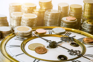 stack of coins on vintage clock