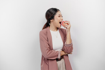 Hungry Asian woman employee is happy about snacking apple, mouth bite healthy food for diet and organic lifestyle, isolated by white background