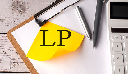 LP word on a yellow sticky with calculator, pen and clipboard