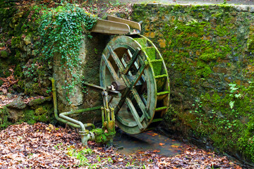 Mill water wheel and dried pond with moss - obrazy, fototapety, plakaty