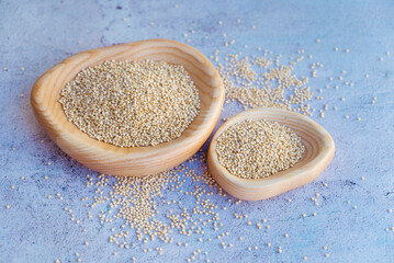 White quinoa seeds in a wooden bowls 