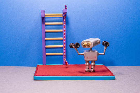Toy robot, powerlifting in the gym. Dumbbells, gymnastic mat and wall bars