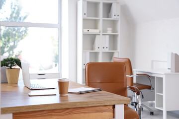 Modern workplace with laptop and coffee cup in office