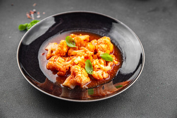 cauliflower tomato sauce stewed vegetable second course healthy eating cooking appetizer meal food snack on the table copy space food background rustic top view 