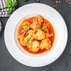 cauliflower tomato sauce stewed vegetable second course healthy eating cooking appetizer meal food snack on the table copy space food background rustic top view 