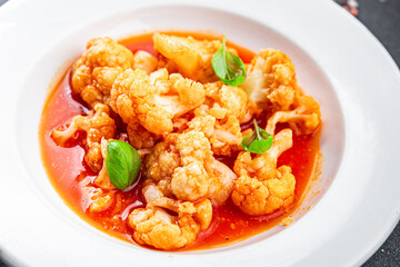 cauliflower tomato sauce stewed vegetable second course healthy eating cooking appetizer meal food snack on the table copy space food background rustic top view 