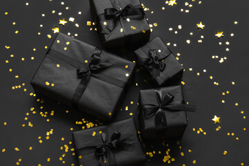 Gift boxes with confetti on dark background. Black Friday sale