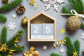 Christmas calendar 25 december. Christmas gift, fir branches, pine cones. Flat lay, top view. New Year decorations on a colored background