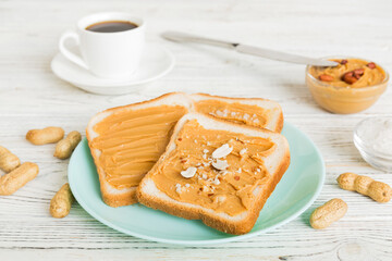 Peanut butter sandwiches or toasts on light table background.Breakfast. Vegetarian food. American cuisine top view vith copy space