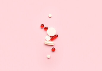 Different medical pills on pink background