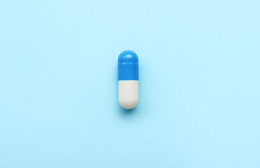 Fototapeta na wymiar Medical capsule on blue background
