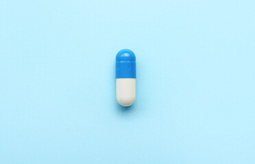 Medical capsule on blue background