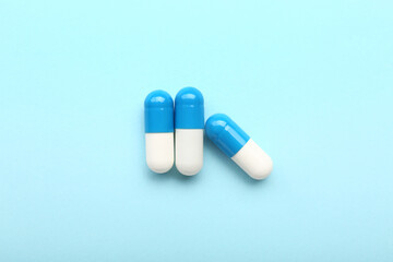 Medical capsules on blue background