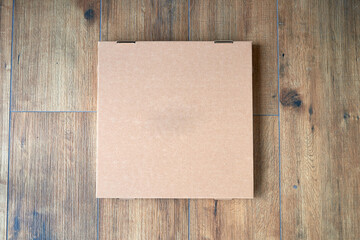 Blank pizza box on Textured Wood Background