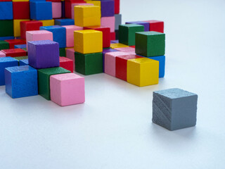 Colored cubes opposite gray. Being different or depression concept.