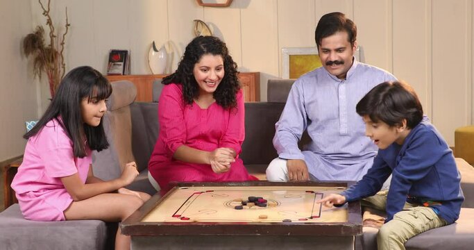 Indian Family Playing Carrom Game At Home
