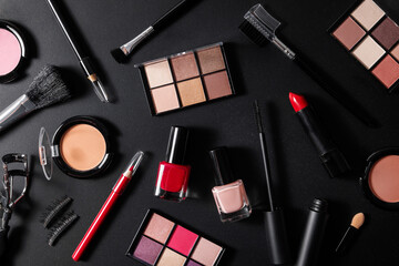 makeup cosmetics set on black background. collection of beauty products. top view
