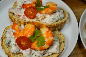 bruschetta bread toast with tomato and prawn with creamy mayonnaise white sauce