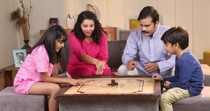 Indian Family Playing Carrom Game At Home
