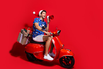 Full size photo of funky young man drive moped megaphone dressed santa claus print x-mas clothes...