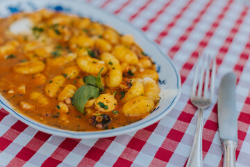 A plate of traditional Italian dish gnocchi for lunch in a cafe.