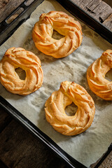 Choux rings. Wooden background, side view. 