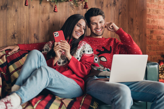 Photo of cute people young wife using smartphone add wishlist tickets abroad winter holiday xmas while man browsing laptop indoors