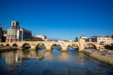 Skopje - Macedonia, October 29, 2023, Stone bridge Skopje, bridge across the Vardar River in Skopje, the capital of the Republic of North Macedonia. - obrazy, fototapety, plakaty