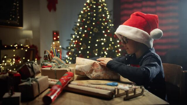 Kid wrapping presents for Christmas on table