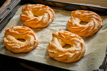 Choux rings. Wooden background, side view. 