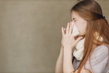 Young woman blowing nose has winter flu catarrh ill sick disease treatment cold