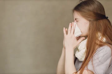 Fotobehang Young woman blowing nose has winter flu catarrh ill sick disease treatment cold © primipil