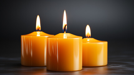 Fototapeta na wymiar Burning candles. Three yellow candles with dark background with copy space. Conceptual image of prayer, supplication, religious request, eternal flame.