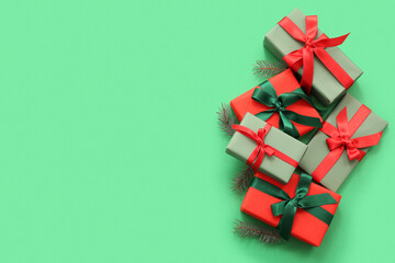 Christmas gift boxes with fir branches on green background
