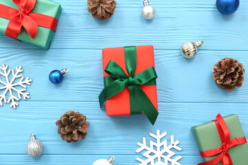 Christmas gift boxes and beautiful decorations on blue wooden background