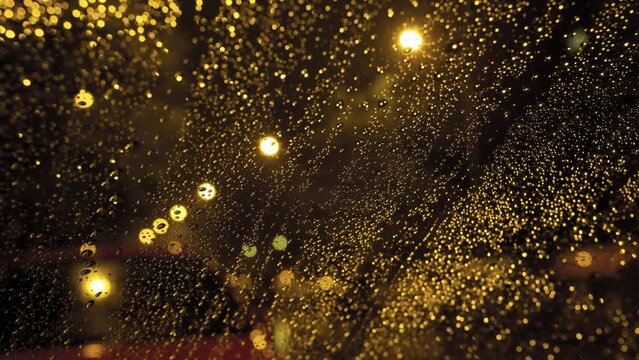 Lights out of focus in the rainy night behind the car windows. City Madrid. Spain. Bokeh. 4
