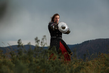 Medieval warrior with sword and small shield in outdoor - 674665681