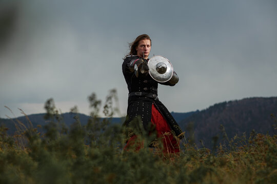 Medieval warrior with sword and small shield in outdoor