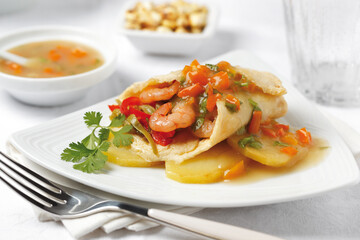 Creamy Omelet with Shrimp, vegetables and cooked potatoes. Easy lunch or breakfast. Side view