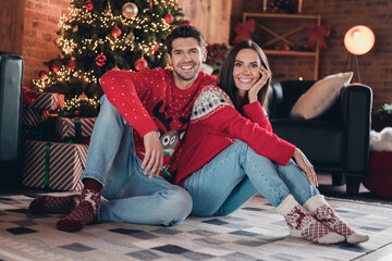 Full body photo of beautiful cute couple young family sitting carpet wearing red deer print sweater...