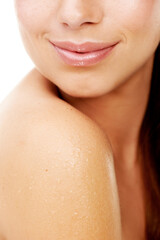 Body, skincare and woman closeup in shower with shoulder, hygiene and white background for dermatology in studio. Girl, water and cosmetics treatment for health, wellness or wet glow on clean skin