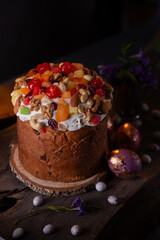 Easter Cake with dried fruits and nutson a wooden table. Delicious traditional bakery and painted eggs for the main orthodox holiday. Happy Easter Background.